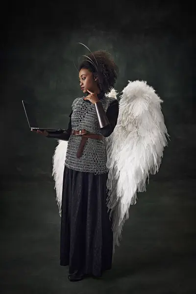 Young African Woman Medieval Warrior Angel Wings Holding Laptop Vintage — Stock Photo, Image