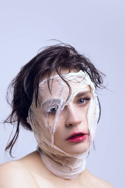 Young woman with bandage on face after facial plastic surgery. Changes. Addicted to modern beauty trends. Concept of modern beauty standards, plastic surgery, health, cosmetology clipart