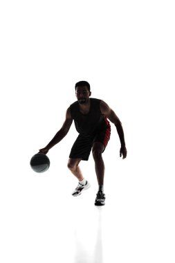 Athletic young man, basketball player in motion with ball, training, playing isolated on white background. Silhouette. Concept of professional sport, competition, game, tournament, action clipart