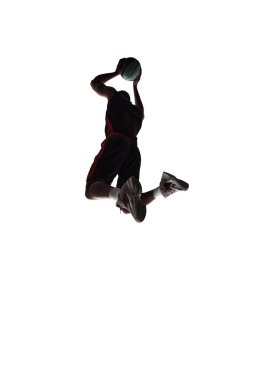 Slam dunk. Silhouette of young man, basketball player in motion during game throwing ball into basket isolated on white background. Concept of professional sport, competition, game, tournament, action clipart