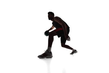 Silhouette of concentrated male athlete, basketball player in motion, dribbling ball isolated on white background. Concept of professional sport, competition, game, tournament, action clipart