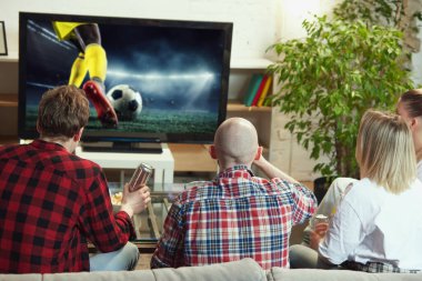 Arkadaşlar, erkekler ve kadınlar çevrimiçi futbol maçı çevirisini izlemek için evde toplanıyorlar. Atıştırmalık yemek, bira içmek. Spor, şampiyonluk, eğlence ve eğlence anlayışı