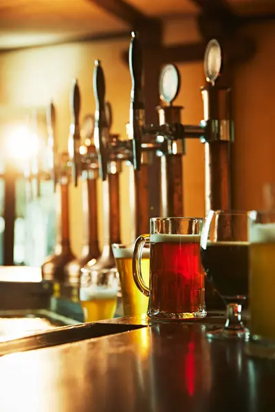 ビールテープの近くに立っている木製のカウンターで さまざまな泡立ったビールの味のグラス 現代のバー パブの美学 ビールドリンク アルコール 醸造所 パブ雰囲気 味のコンセプト — ストック写真