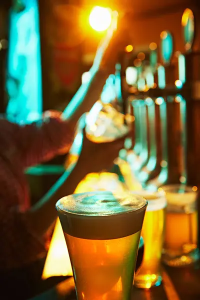 Focus Glass Foamy Lager Beer Blurred Image Bartender Pouring Another — Stock Photo, Image