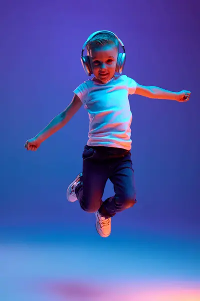 Schoolboy Casual Attire Jumping Joy While Dancing Listening Music Headphones — Stock Photo, Image
