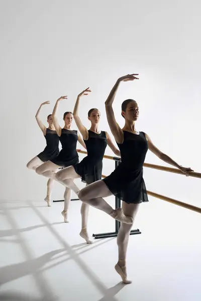 Dynamic Ballet Sequence Elegant Teen Girls Ballet Dancers Standing Barre – stockfoto