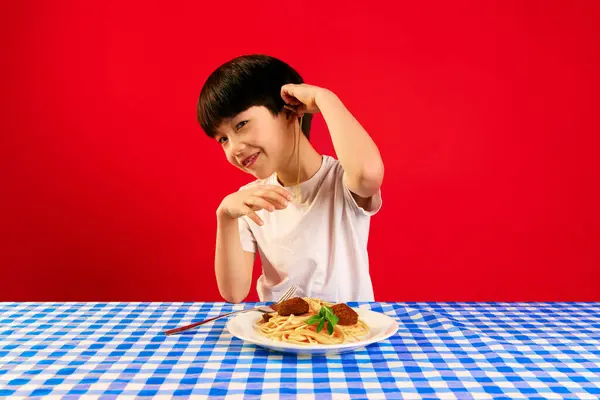 Little Smiling Boy Sitting Table Pasta Meatballs Putting Spaghetti Ear — Stock Photo, Image