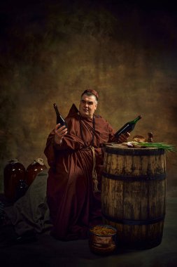 Medieval monk sitting in dark lit space and looking at two bottles of red wine. Wooden barrel, wine bottles. Winemaking industry. Concept of comparison of eras, history, brewery, Oktoberfest clipart