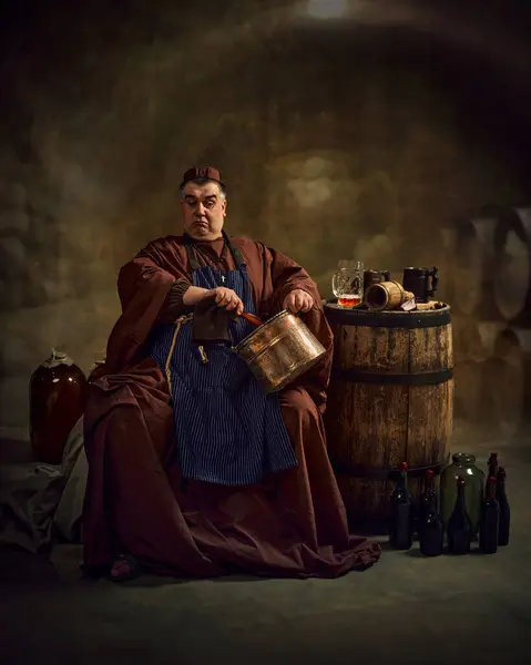 stock image Medieval monk stirring copper pot, craft of abbey ale, beer production in serene monastic setting. Concept of comparison of eras, history, brewery, traditions, degustation, Oktoberfest