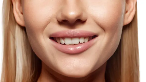 stock image Beautiful female lips, white teeth and perfect nose. Close-up cropped image of female lower face part with well-kept skin. Concept of plastic surgery, medical cosmetology, lip augmentation