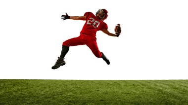 Kararlı bir sporcunun dinamik görüntüsü, stadyumda hareket halindeki Amerikan futbolcusu, odaklanarak top atan, oynayan. Spor anlayışı, rekabet, turnuva, oyun. Boşluğu kopyala