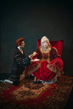 Humorous scene with elderly woman and young man, Medieval empress sitting in chair with young male servant doing painting her nails. Concept of history, comparison of eras, beauty routine clipart