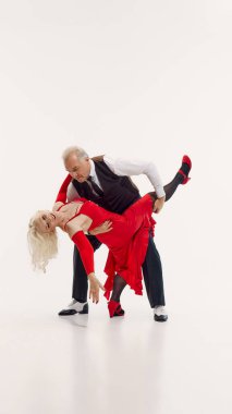 Tango aesthetic through years. Elderly beautiful woman and handsome senior man, couple dancing tango isolated on white background. Concept of retro dance, hobby, aging, active lifestyle clipart