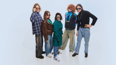 Stylish group of friends, men and women in 90s-inspired clothing, featuring plaid shirts, leather jackets, and denim posing against white studio background. Concept of 90s fashion, retro style, youth clipart