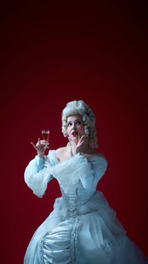 Neşeli bir zarafet. Rococo peruklu ve beyaz elbisesi olan genç bir kadın elinde şarap bardağıyla küstah bir ifadeyle poz veriyor. Tarihi portre, ortaçağ, karakter, mizah, moda kavramı.