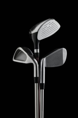 Three golf clubs positioned against black backdrop in sharp detail. Concept of sports gear catalogs, precision performance visuals, golfing lifestyle and modern advertising.