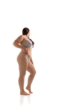 Confident plus size woman posing in lingerie with graceful curves and proud emotion. Concept of body positivity, fashion editorial, lifestyle branding, inclusivity and empowerment visuals.