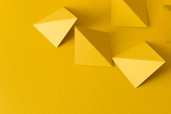 Yellow abstract background with triangle shapes, copy space