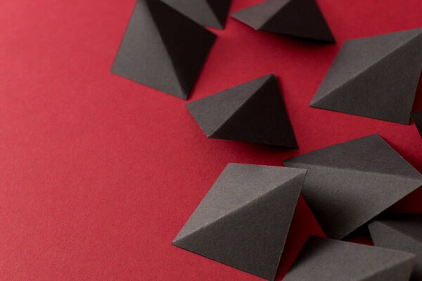 Black geometric shapes on red background, copy space