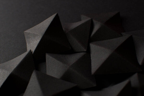 Black abstract background with geometric shapes, close up