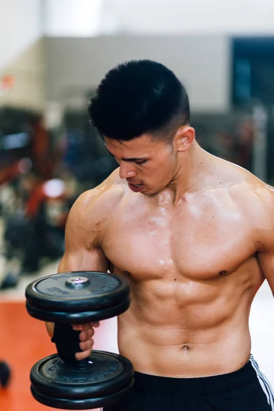 stock image Shot on a man lifting dumbbells in a gym.