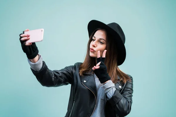 Mladá Dívka Sobě Hipster Klobouk Přičemž Selfie Proti Modré Zdi — Stock fotografie