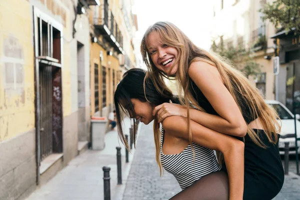 布鲁内特在街上接她的金发女友 开心地笑着 — 图库照片