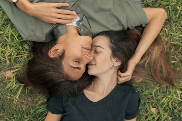 額に草の額に横たわっている愛の若いカップルの閉鎖ショット — ストック写真