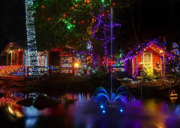 Renkli dekorasyonlar rahat kulübeler ve ağaçlar süsler, büyülü bir atmosfer yaratır. Parlak ışıklar çevreyi aydınlatır ve suda parlar, neşeli ruhu güçlendirir..