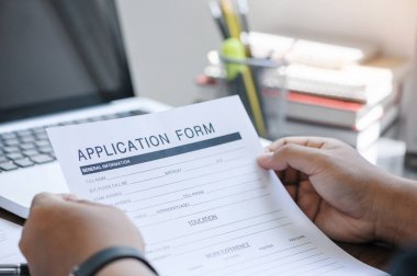 business man working on laptop computer and application Form Information for the searching job or fill out personal data for online web job the application form. Employment Concept.