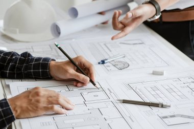 Team engineer or architect meeting for project working with partner and engineering tools on model building and blueprint in working site. Construction concept