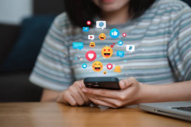 Women using smartphone playing social media press the button emoji, hearts and chat happiness. Social media and digital online concept. 