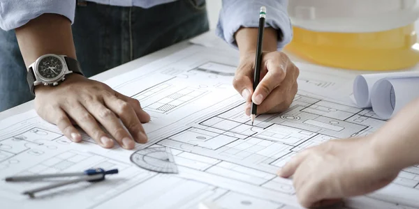 close up of team engineer or architect meeting for project working with partner and engineering tools on model building and blueprint in working site. Construction concept