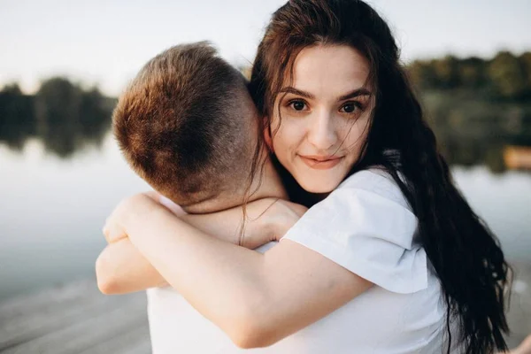 Chica Abrazando Joven Cerca Del Río Atardecer —  Fotos de Stock