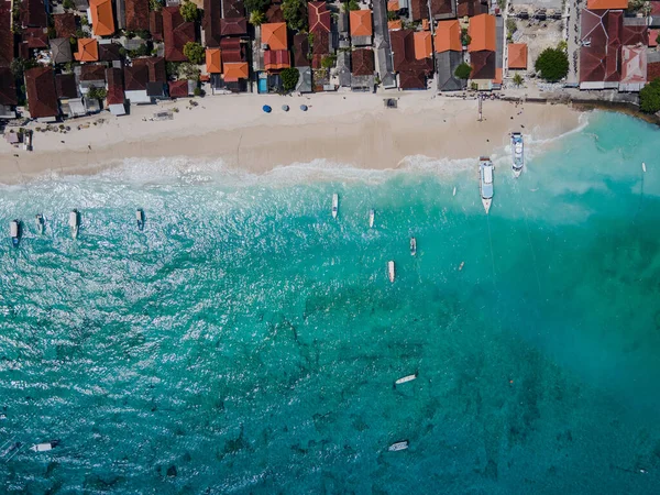 stock image Aerial shoreline view of Jungutbatu beach at Nusa Lembongan with tourist speedboat anchored. One of travel destinations close to Bali island, Indonesia.