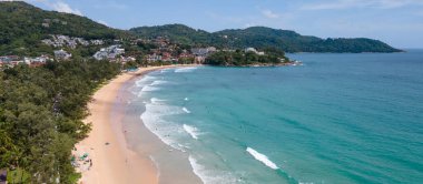 Düşük mevsimde sörf tahtalarında sörf yapan sörfçülerin olduğu Kata Sahili 'nin hava manzarası. Phuket, Tayland 'daki popüler seyahat merkezlerinden biri. Andaman Denizi 'nin güzel yaz manzarası