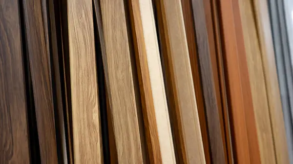 Sample of wood plank material in home design store. Wooden laminate floor finishing for house interior decoration