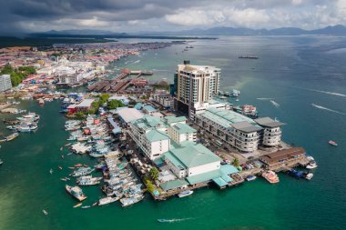 Aerial drone view of commercial pier and fisherman village at Semporna, a city on east coast of Sabah in Malaysia, Tawau District, Borneo island clipart