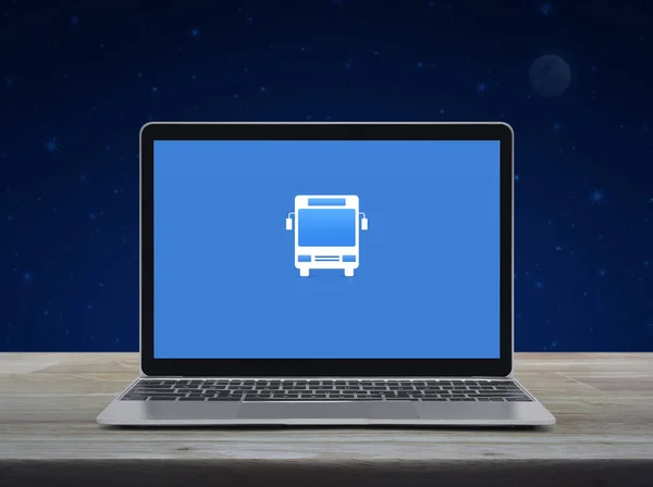 幻想的な夜空と月の上に木製のテーブルの上に現代のラップトップコンピュータモニタ画面上のバスフラットアイコン ビジネス交通オンラインサービスの概念 — ストック写真
