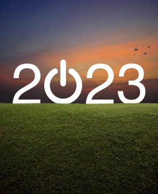 2023 start up business flat icon on green grass field over sunset sky with birds, Happy new year 2023 concept clipart