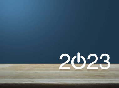 2023, ahşap masanın üzerinde yeni iş simgesi oluşturun. Açık mavi duvarın üzerinde. Mutlu yıllar 2023 başarı konsepti.
