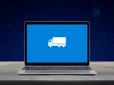 Delivery truck flat icon on modern laptop computer screen on wooden table over fantasy night sky and moon, Business transportation online service concept