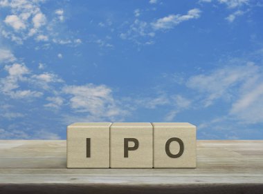 Tahta blok küplere halka arz mektubu mavi gökyüzü üzerinde beyaz bulutlu ahşap masa üzerinde ilk halka arz konsepti