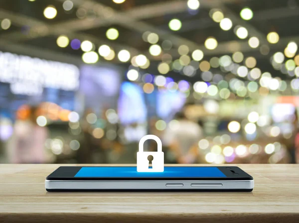 Key flat icon on modern smart mobile phone screen on wooden table over blur light and shadow of shopping mall, Business internet security and safety concept
