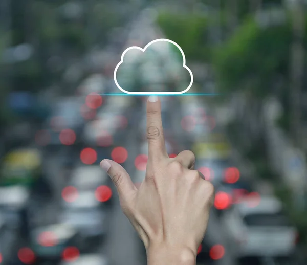 Hand click on cloud computing icon with copy space over blur of rush hour with cars and road in city, Technology cloud computing concept