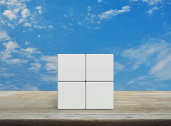 stock image Four white block cubes on wooden table over blue sky with white clouds