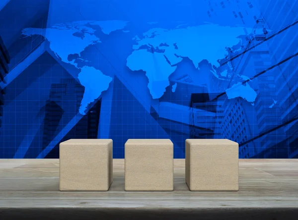 Three block cubes on wooden table over world map, modern office city tower and skyscraper, Elements of this image furnished by NASA