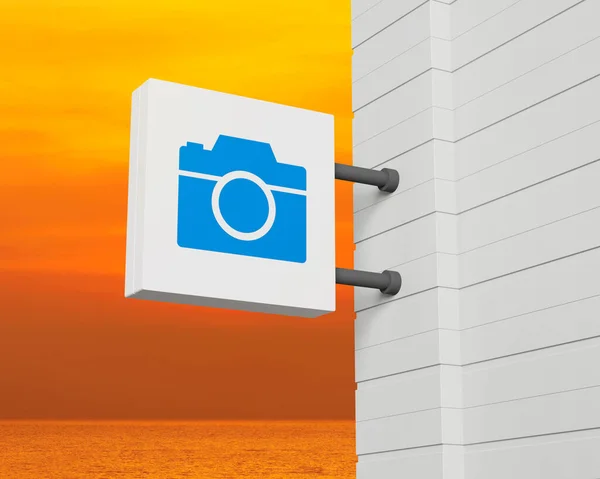 夕日の空と海の上に白い四角形の看板をぶら下げ上のカメラアイコン ビジネスカメラサービスの概念 3Dレンダリング — ストック写真