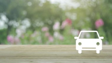 Otomobil yassı simgesi ahşap masa üzerinde bulanık pembe çiçek ve parktaki ağaç üzerinde, iş taşımacılığı hizmeti konsepti