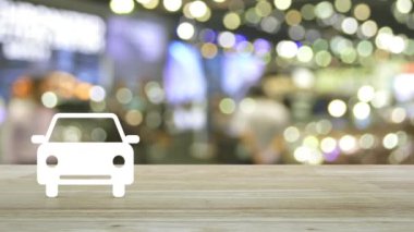 Bulanık ışık ve alışveriş merkezinin gölgesi üzerindeki ahşap masa üzerindeki araba dairesi simgesi, iş taşımacılığı hizmeti konsepti
